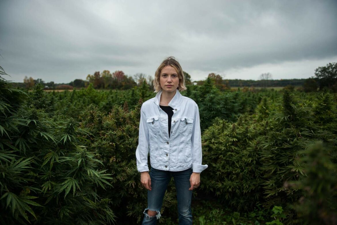 Melany Dobson, chief brand officer at Hudson Hemp, walking in the cannabis at Old Mud Creek Farm.