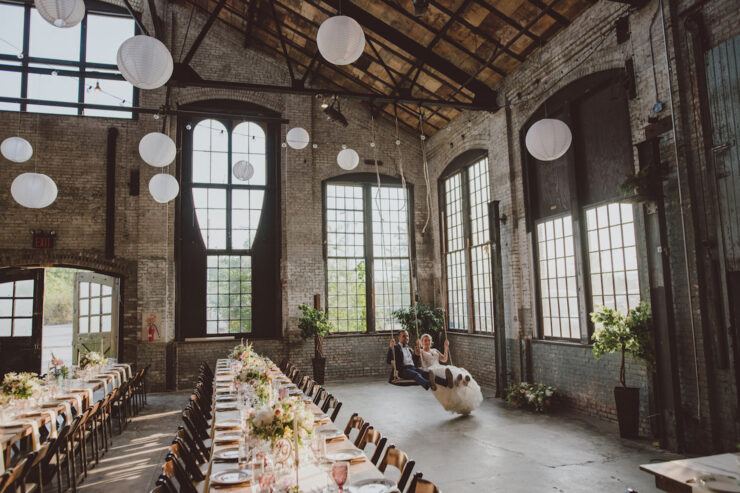 wedding venue with set of table and chairs to left and swings to the right