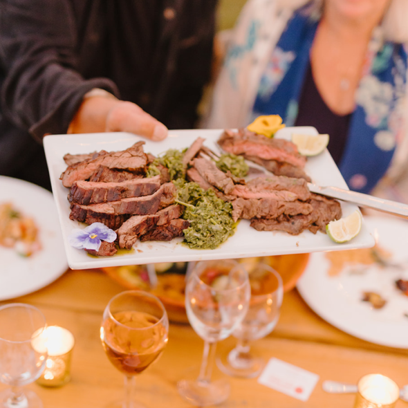 a person passing a platter of food being passed around at an event