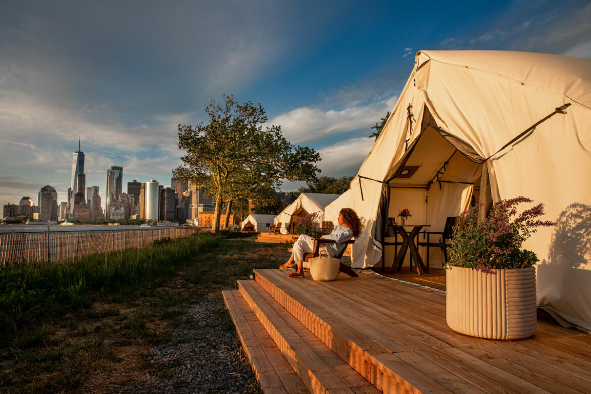 woman camping on governors island looking at nyc skyline